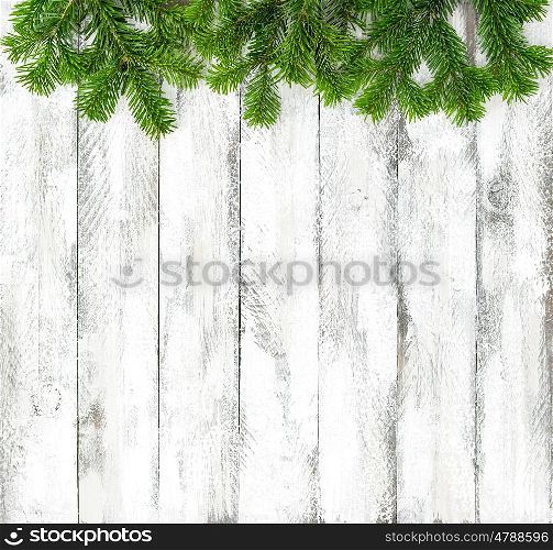 Christmas tree branches on bright wooden background. Winter holidays