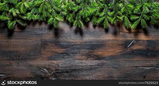 Christmas tree branches on dark wooden background