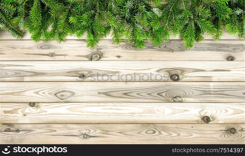 Christmas tree branches on wooden background. Winter holidays