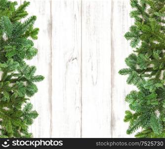 Christmas tree branches on wooden background. Winter holidays decoration