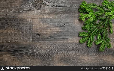 Christmas tree branches on wooden texture. Retro style holidays background