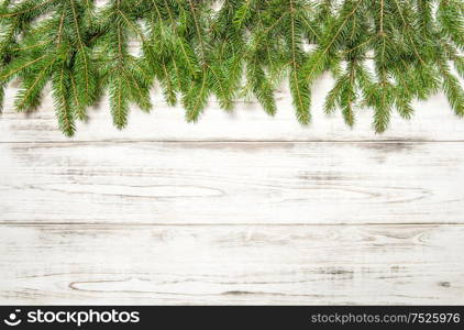 Christmas tree branches on wooden texture. Winter holidays background