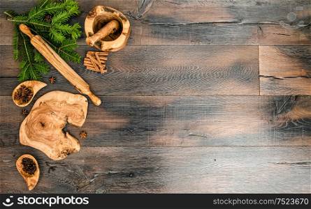Christmas tree branches with spices and baking tools. Holidays food background