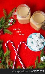 Christmas tree, candy, coffee marshmellou on a red background. The inscription Happy New Year.. Christmas tree, candy, coffee marshmellou on a red background. The inscription Happy New Year
