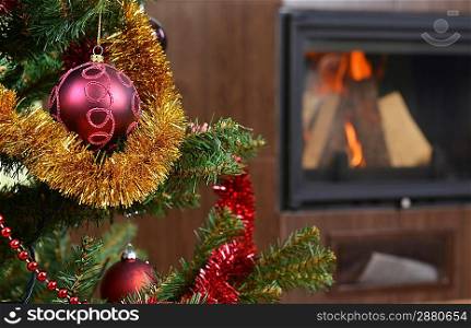 Christmas tree decorations in interior with fireplace