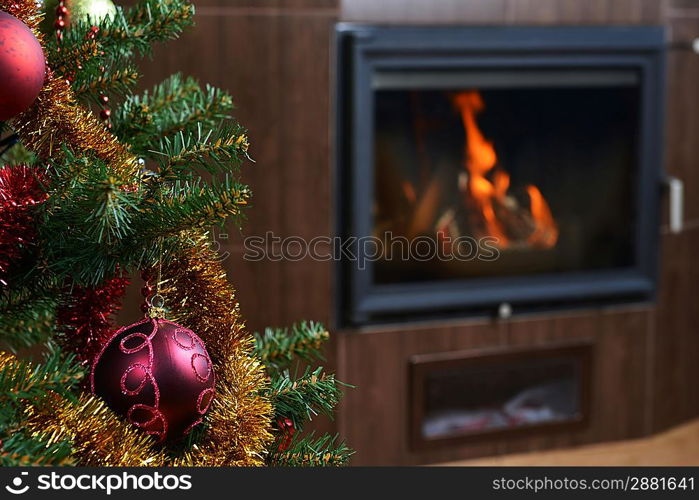 Christmas tree decorations in interior with fireplace