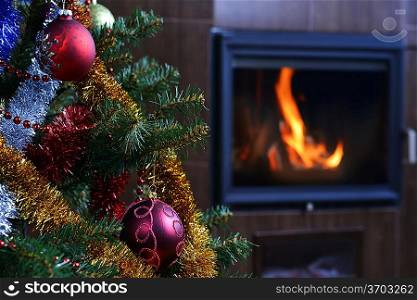 Christmas tree decorations in interior with fireplace
