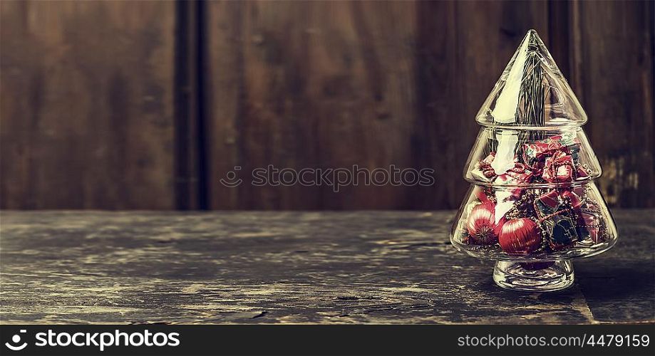 Christmas tree from glass with decorations on rustic wooden background, banner