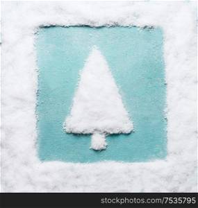 Christmas tree made with snow with snow frame at blue background. Modern creative winter holiday concept