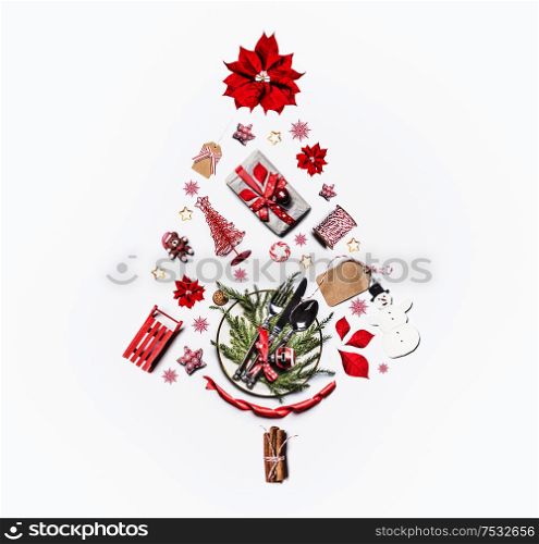 Christmas tree made with various Christmas objects on white background