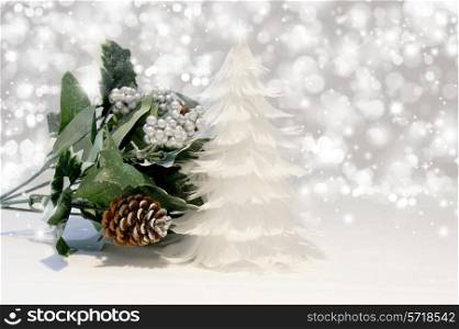 Christmas tree of feathers and greenery on silver starry background