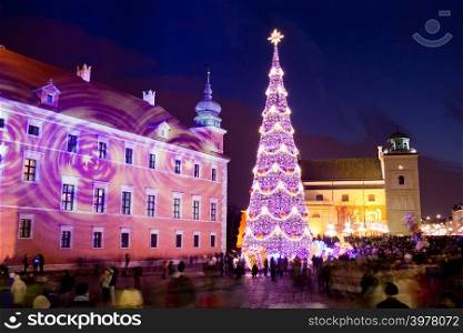 Christmas Tree on Castle Square at the Old Town of Warsaw in Poland, illuminated at night.