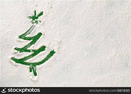 Christmas tree on snow flour background. Copy space. Top view, flat lay