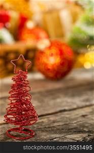 Christmas tree on wooden table against decorations