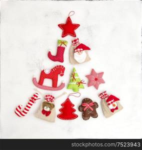 Christmas tree shaped from ornaments, decorations and gift bags. Holidays background