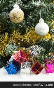 christmas tree shiny christmas balls and gift boxes on snow