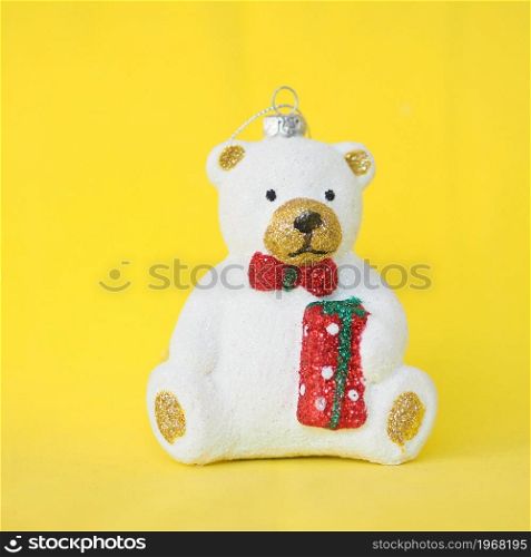 Christmas tree toy cute white teddy bear on a yellow background.