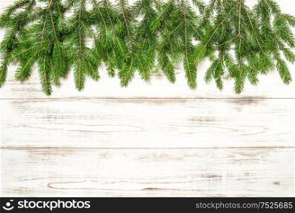 Christmas tree twigs on wooden background. Winter holidays concept