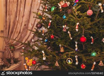 Christmas tree with candies and decor close up. Christmas tree in living room