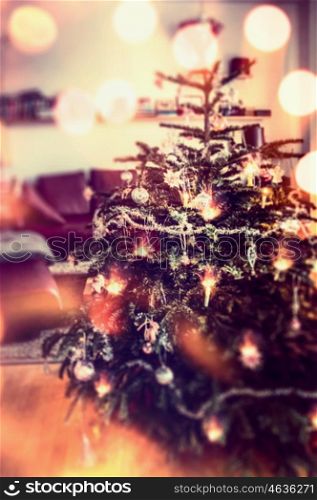Christmas tree with decoration and holiday lighting with bokeh, festive home scene, blurred