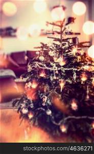 Christmas tree with decoration and holiday lighting with bokeh, festive home scene, blurred
