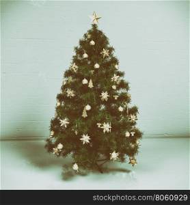 Christmas tree with decorations on light background. Retro effect