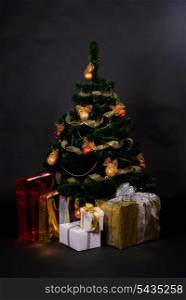 christmas tree with different gifts isolated on black