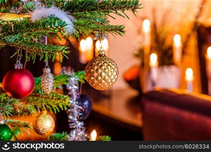 Christmas tree with shiny baubles in a living room