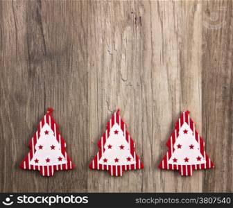 christmas trees red and white on wooden background