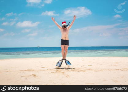 Christmas vacation - man in santa hat on the Maldives tropical beach