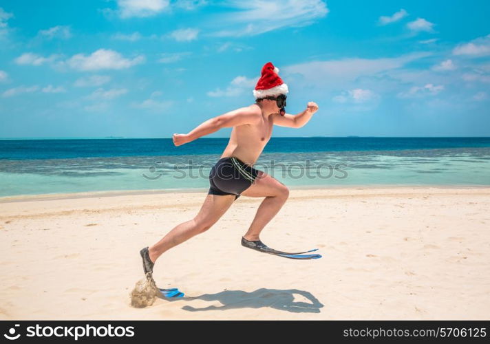 Christmas vacation - man in santa hat on the Maldives tropical beach