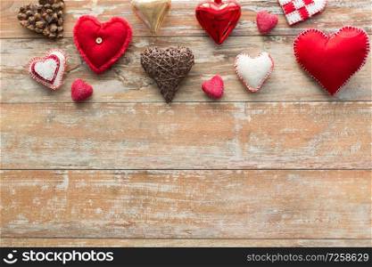christmas, valentines day and holidays concept - heart shaped decorations on wooden background. heart shaped decorations on wooden background