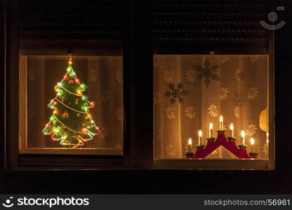 Christmas window with lights decoration. Advent light. Christmas tree.