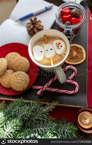 christmas, winter holidays and leisure concept - close up of marshmallow snowman in cup of coffee. marshmallow snowman in cup of coffee on christmas