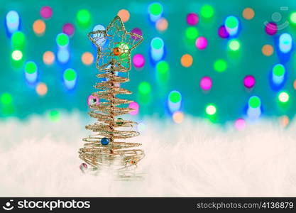 christmas wire tree on white fur and colorful lights