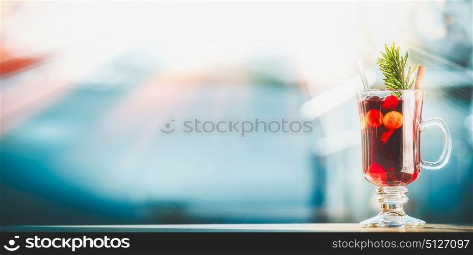 Christmas with glass of mulled wine at winter day background, front view, banner