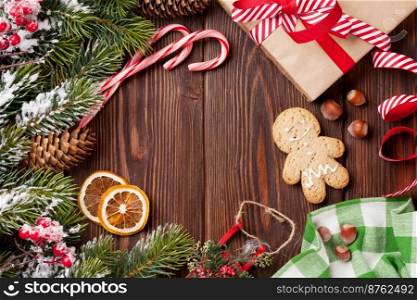 Christmas wooden background with snow fir tree, decor and gift box