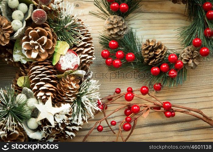 Christmas wreath formed by natural elements and branch with red fruits