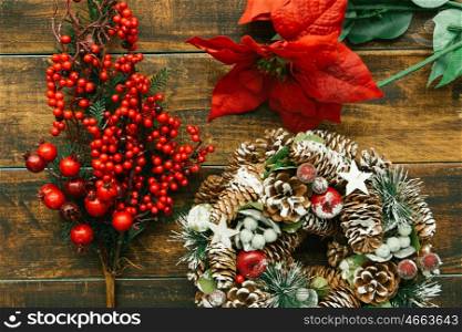 Christmas wreath formed by natural elements and branch with red fruits