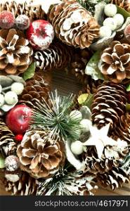 Christmas wreath formed by natural elements: pine cones, fruits, ...