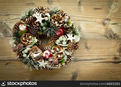 Christmas wreath formed by natural elements: pine cones, fruits, ...