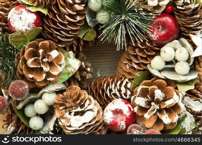 Christmas wreath formed by natural elements: pine cones, fruits, ...