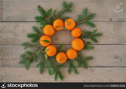 Christmas wreath from oranges and fir branches. Flat lay, alternative decorations. Decor idea or postcard