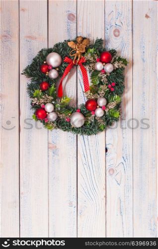 Christmas wreath hanging on blue wooden wall. Christmas wreath on wall