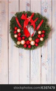 Christmas wreath hanging on blue wooden wall. Christmas wreath on wall