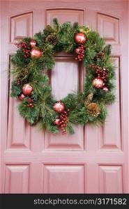 Christmas wreath hanging on door.