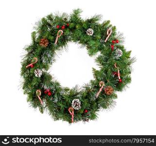 Christmas wreath isolated on white background. Decorated with candy canes, cones and red berries.