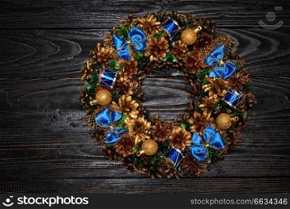 Christmas wreath on dark wooden background. Christmas wreath on wooden background