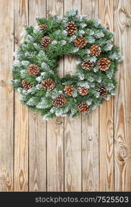 Christmas wreath on rustic wooden background. Christmas decoration