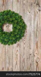 Christmas wreath on rustic wooden background. Festive decoration